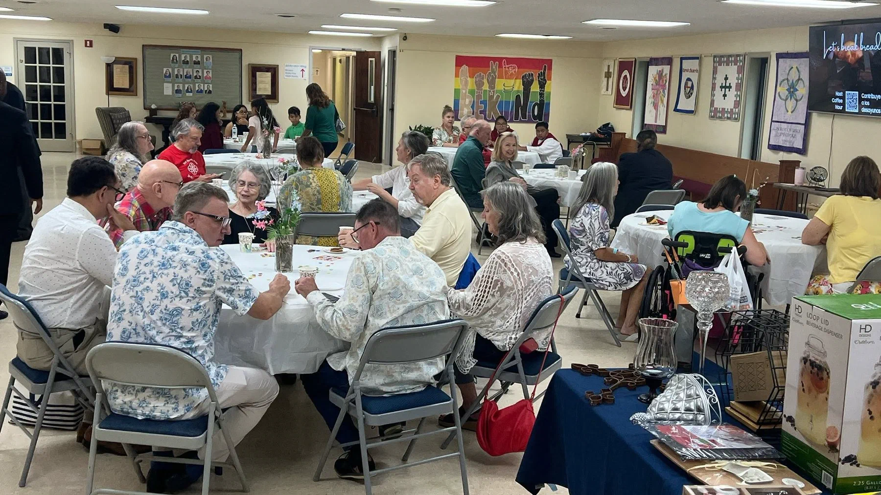 A full parish hall playing bingo at tables.
