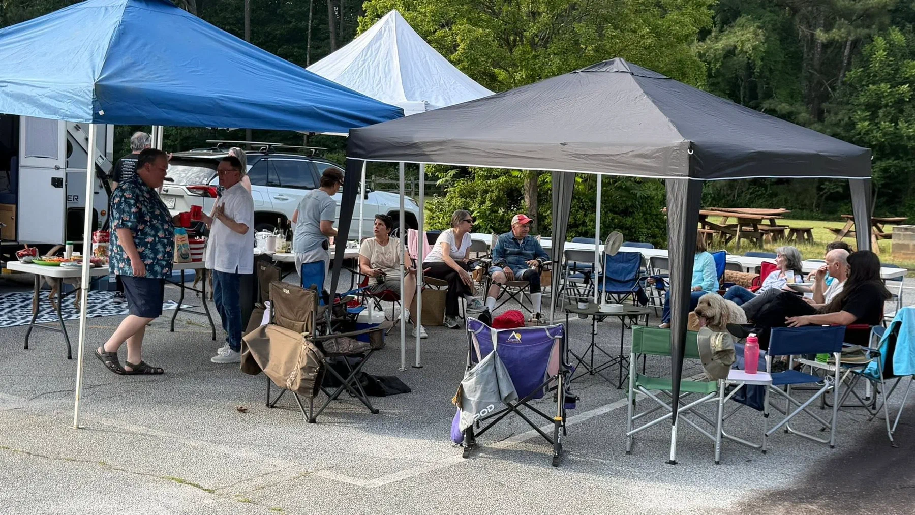 Parishioners under shade canopies at the parish camporee.