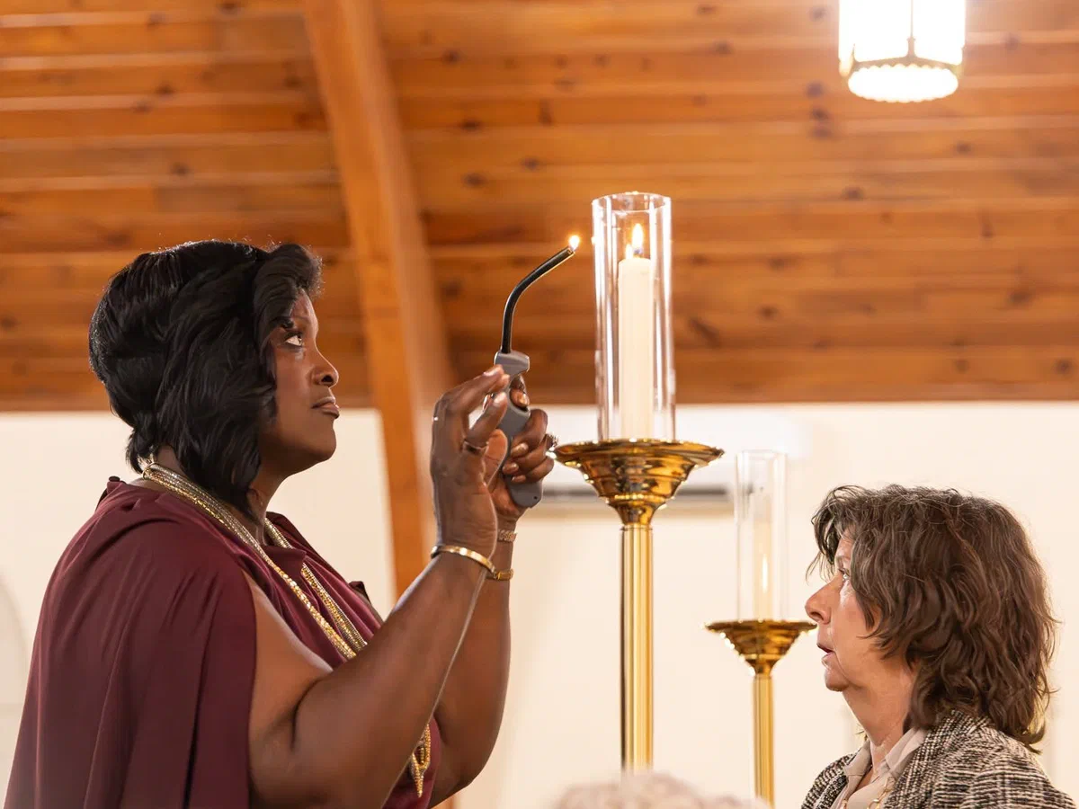 A parishioner lighting a candle in the Nave.