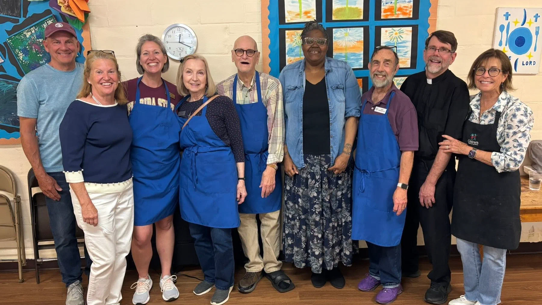 Christ Church volunteers in aprons after serving a community meal.