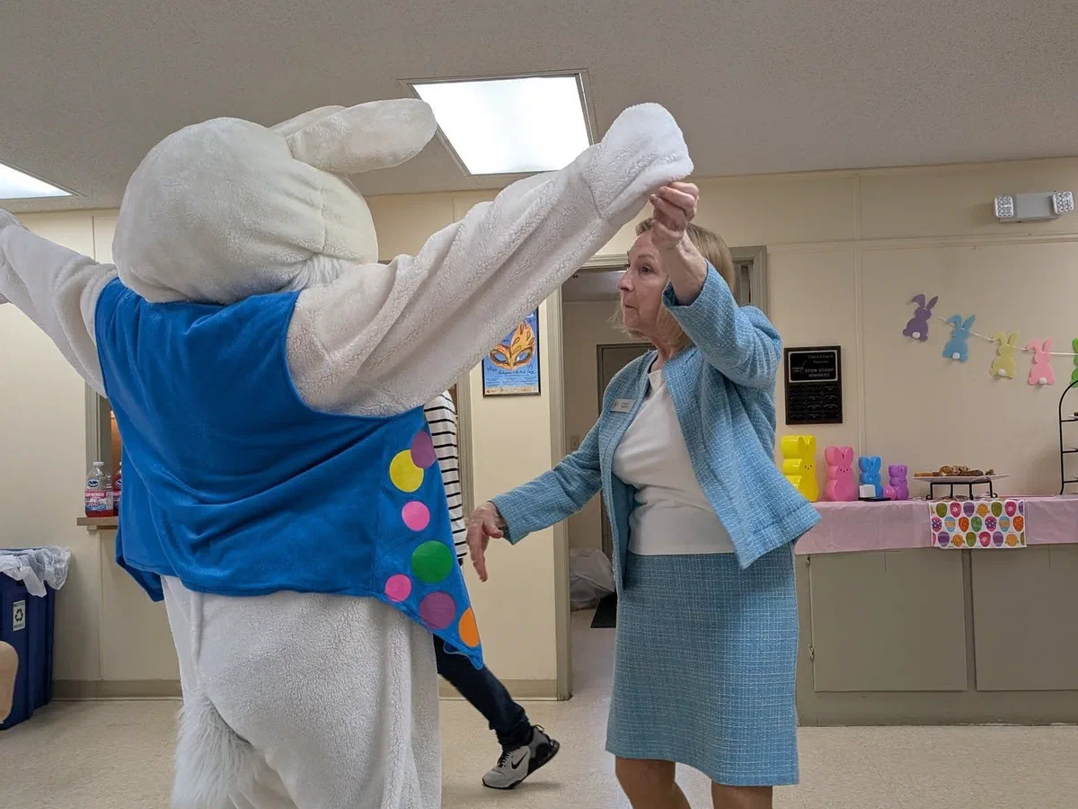 The Easter Bunny dancing with a parishioner at the parish Easter party.